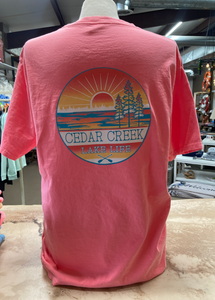 A neon coral t-shirt on a mannequin featuring a Cedar Creek Lake Life logo on the back.