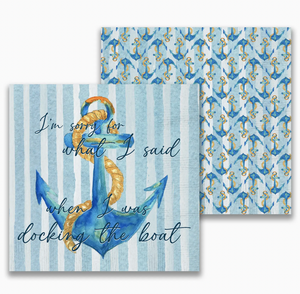 A display of blue and white striped cocktail napkins with a central anchor design surrounded by smaller anchors, featuring the playful text "I'm sorry for what I said when I was docking the boat".