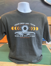 Load image into Gallery viewer, A full view of a dark gray ringspun cotton t-shirt displayed on a mannequin, showing the solar eclipse design with &#39;CEDAR CREEK LAKE - TEXAS&#39; on top and the event date &#39;04/08/2024&#39; below.