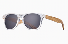 Load image into Gallery viewer, Transparent crystal-framed Bodie sunglasses with zebra wood temples, spring hinges, and 100% polarized smoke lenses for UVA/UVB protection, eco-sustainable fashion accessory.